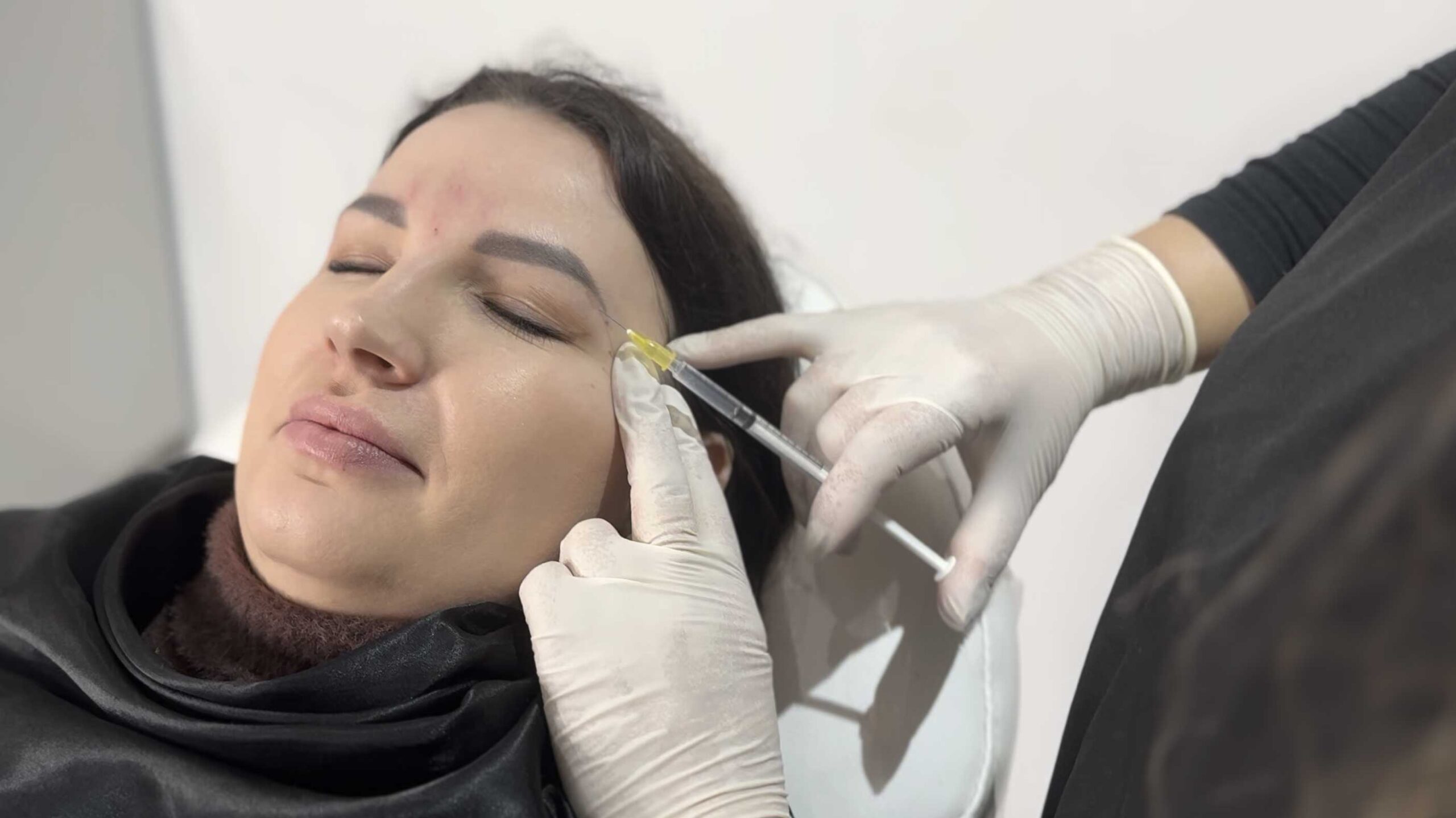 Aesthetician Emel Kucuk discussing Botox treatment options at her Islington clinic